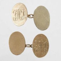 A pair of 9 carat gold cufflinks, each of oval shape, with engine turned decoration, engraved with a