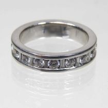 An 18 carat white gold diamond full hoop eternity ring, set with a frieze of sixteen diamonds,