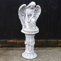 A cast stone garden statue of an angel on a plinth base, 100cm high