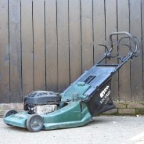 An Atco petrol lawnmower Shows signs of use/age, but starts and runs ok.