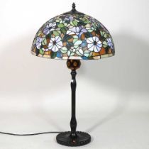 A Tiffany style metal table lamp, with a stained glass shade, 75cm high