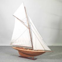 A wooden model of a yacht, on stand, 115 x 131cm