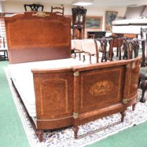 A mid 20th century French yew, satinwood and marquetry double bedstead, with gilt metal mounts on