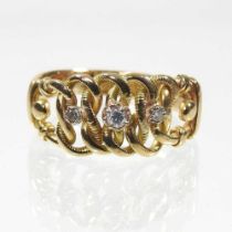 An 18 carat gold diamond three stone ring, of interlaced design, set with a row of graduated stones,