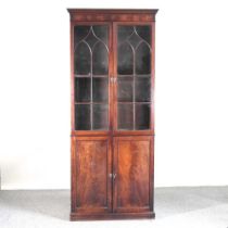 A 19th century mahogany cabinet bookcase, fitted with shelves, with panelled doors below. Note: a