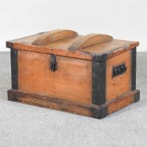 An antique iron bound hardwood chest, with a hinged lid 67w x 40d x 40h cm