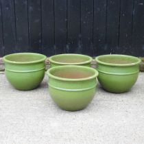 A set of four large green glazed garden pots, each 33cm high (4)