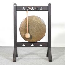 A Victorian copper dinner gong, on a wooden stand, 92cm high overall Overall complete and usable.