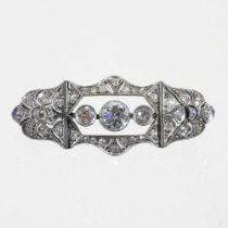 An unmarked Art Deco diamond brooch, the central collet set diamond approximately 0.5 carats,