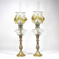 A pair of brass oil lamps, with frilled glass shades, 51cm high (2)