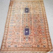 A Baluchi carpet, with two central lozenges, on a red ground, 238 x 160cm