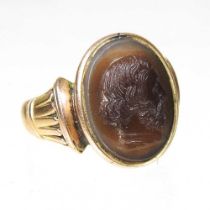 A large carnelian signet ring, carved with a cameo portrait head of a man in profile, unmarked, 2cm,