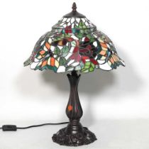 A Tiffany style table lamp, with a stained glass shade, 55cm high