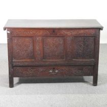 An 19th century carved oak mule chest, with a hinged lid and single drawer below 114w x 48d x 75h