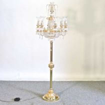 An ornate modern brass six branch floor lamp, with crystal drops, on a scrolled base, 175cm high
