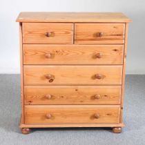 A modern pine chest of drawers, on turned feet 85w x 37d x 94h cm