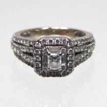 An 18 carat white gold diamond cluster ring, with diamond set shoulders, approximately 1.0 carat