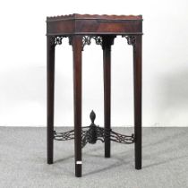 An Edwardian mahogany urn table, with fret carved decoration 35w x 34d x 72h cm