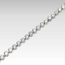 An 18 carat gold tennis bracelet, set with a single row of forty-seven collet set diamonds, with a