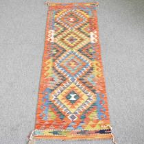 A kilim runner, with a row of four central diamonds, 197 x 63cm