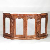 A Victorian burr walnut credenza, of serpentine shape, with a white marble top and mirrored doors,