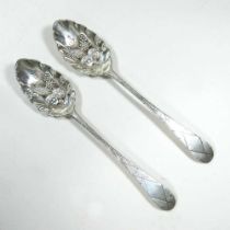 A pair of George III and later decorated silver table spoons, decorated in relief with pineapples