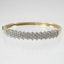 A diamond set hinged bangle, pave set with a row of sixty diamonds, marked indistinctly, 18.9g, 60mm