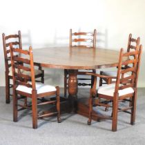 An oak circular dining table, 147cm diameter, together with a set of five ladderback dining