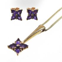 A 9 carat gold and amethyst necklace and earring set, comprising a necklace with a floral pendant,