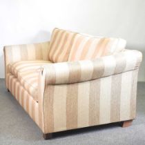 A gold striped upholstered sofa, with loose cushions 225w x 100d x 88h cm