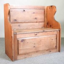 A pine box settle, with a rising seat 92w x 42d x 87h cm