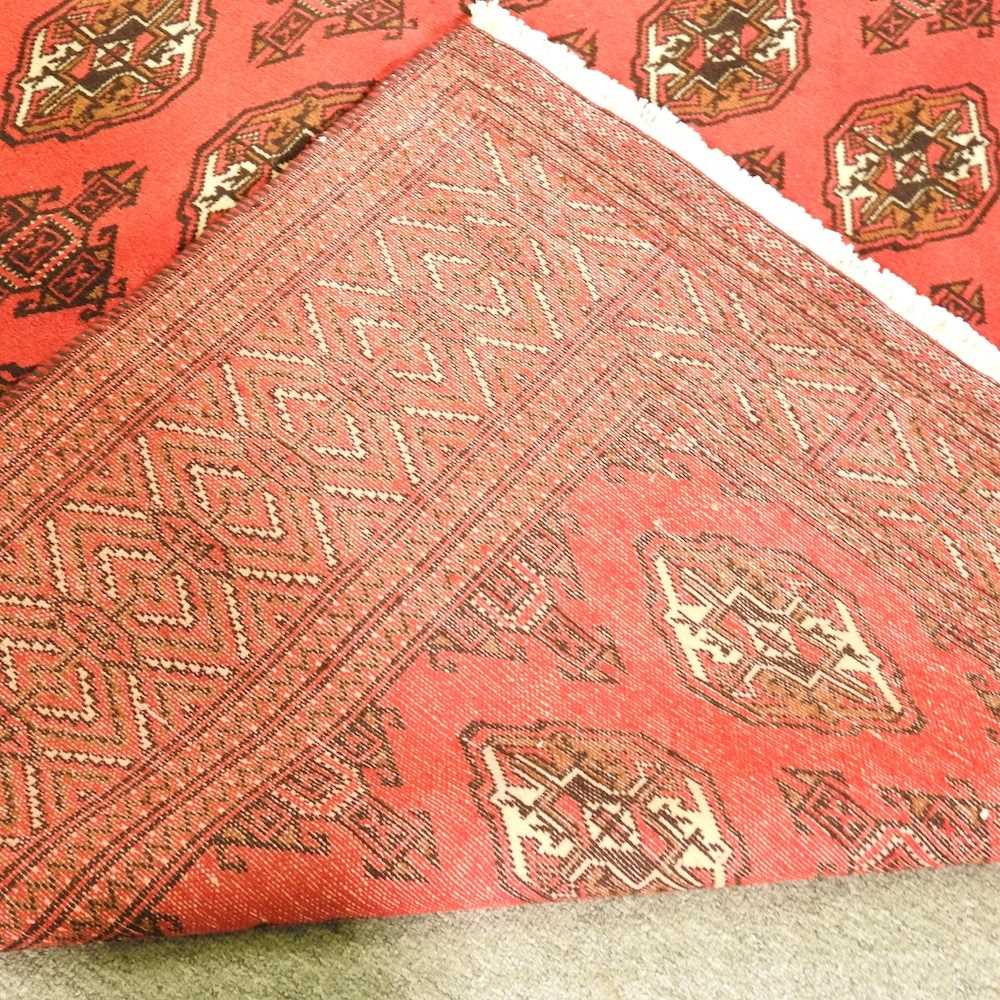 A Persian carpet, with rows of alternating medallions, on a red ground, 289 x 197cm - Image 5 of 5