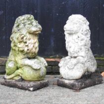 A pair of reconstituted stone garden statues of seated lions, 61cm high