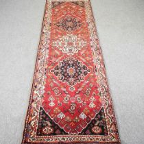 A Persian qashqai runner, with floral designs, 275 x 88cm