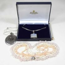 A large filigree pendant necklace, together with a crystal necklace and a simulated pearl four