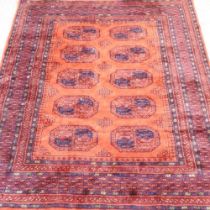 An Afghan rug, with two rows of medallions, on a red ground, 229 x 172cm