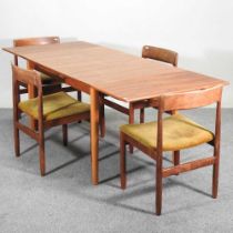 A 1960's teak G Plan style dining suite, comprising a draw leaf dining table and a set of four