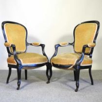 A pair of 19th century ebonised and green upholstered armchairs, on cabriole legs (2)