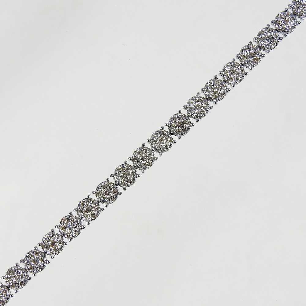 A 9 carat white gold diamond set line bracelet, set with approximately 3.0 carats of diamonds,