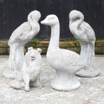 A cast stone garden statue of a duck, 52cm high, together with a pair of herons and a dog (4)
