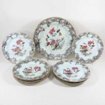 A suite of nine 18th century Chinese export porcelain famille rose plates, Qianlong period, each