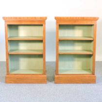 A pair of hand made walnut and crossbanded dwarf open bookcases, each with painted shelves, on a
