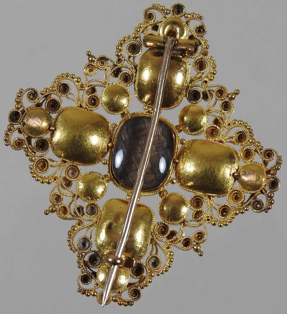 A 19th century unmarked gilt filigree brooch, set with garnets and pearls, with plaited hair inset - Image 3 of 3