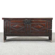 A small 18th century oak six plank coffer, with a hinged chip carved lid and lozenge carved