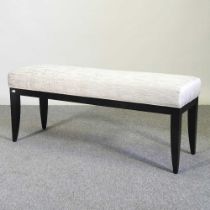 A modern ebonised stool, with an upholstered seat 109w x 36d x 44h cm