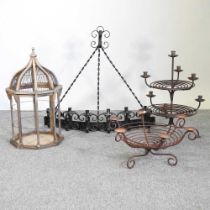 Three iron candlestick holders, together with a birdcage, 64cm high (4)