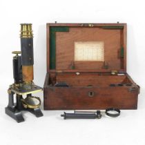 An early 20th century microscope, 27cm high, in a fitted mahogany case