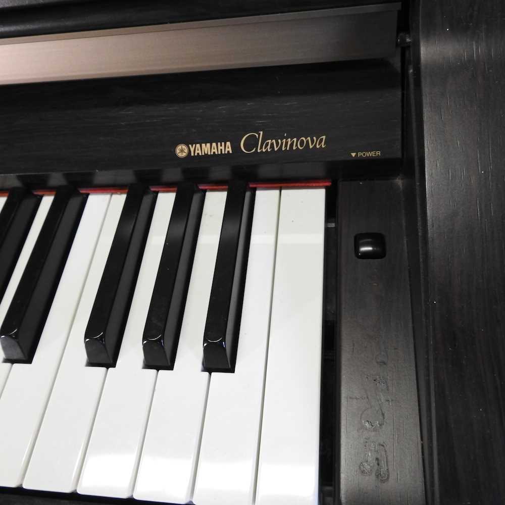 A Yamaha electric Clavinova piano, in an ebonised case, together with two piano stools (3) 136w x - Image 3 of 10