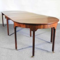 A George III style mahogany extending D-end dining table, 20th century, with a drop leaf central