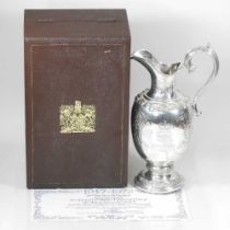 A Garrard silver wine jug, of baluster shape, with a scrolled handle, to commemorate the silver